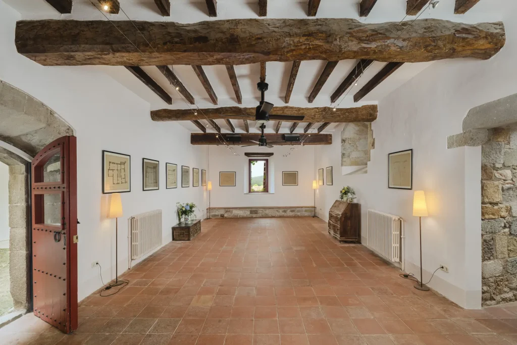 Espai interior ampli amb terres ceràmics i bigues vistes