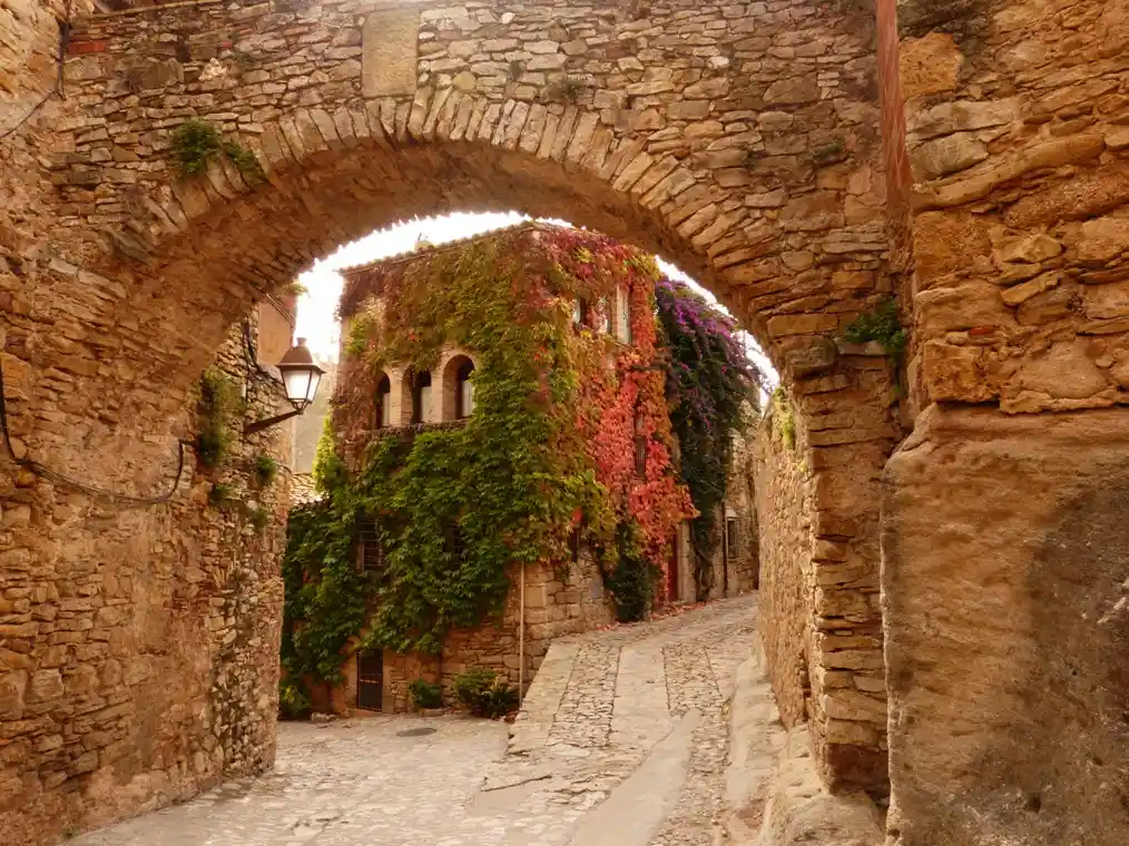 Arco de piedra y calle medieval en el pueblo de Peratallada